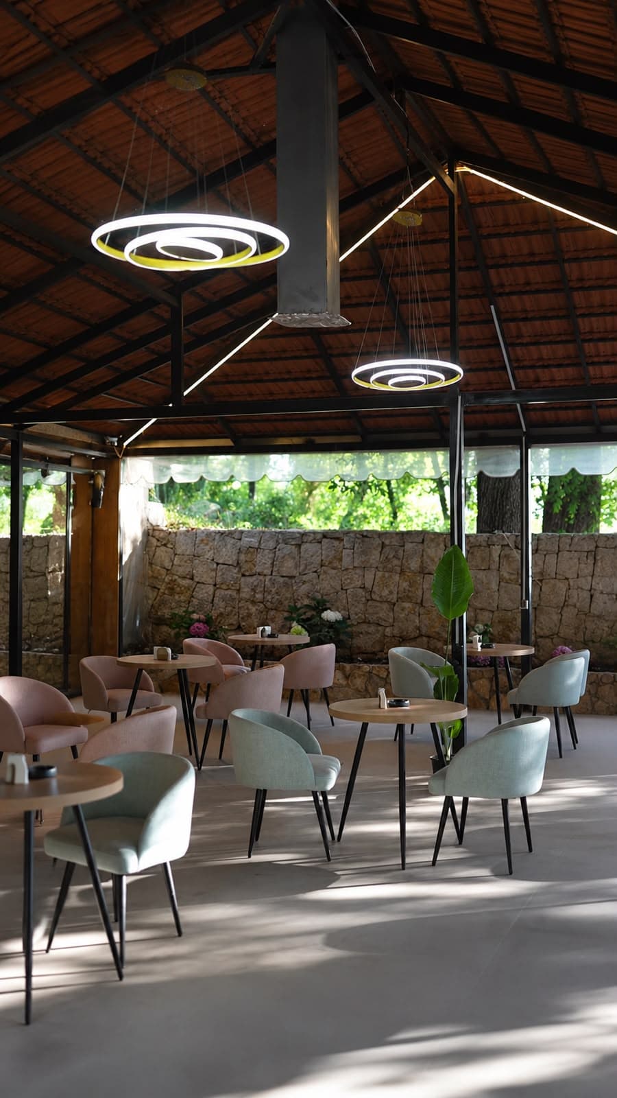 Open-air seating under circular hanging lights at The Lawn Cafe